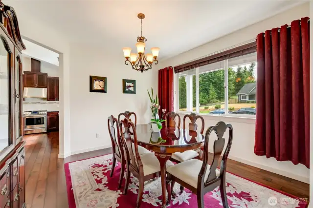 Adjacent to the kitchen, the expansive formal dining room is flooded with natural light and large enough to host holidays, dinner parties, and special occasions with ease.