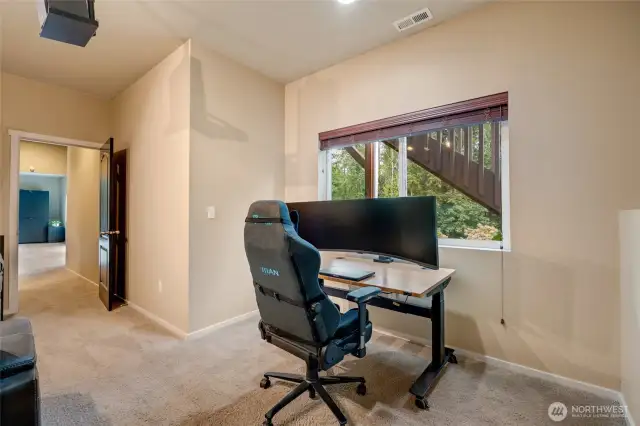 A large window overlooks the backyard, filling the space with natural light and warmth.