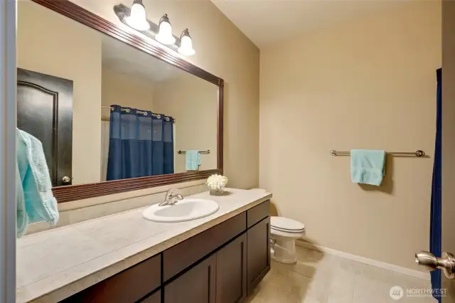 You won’t lack for convenience, as the lower level also features a full-sized bathroom, ensuring everyone has a private space.