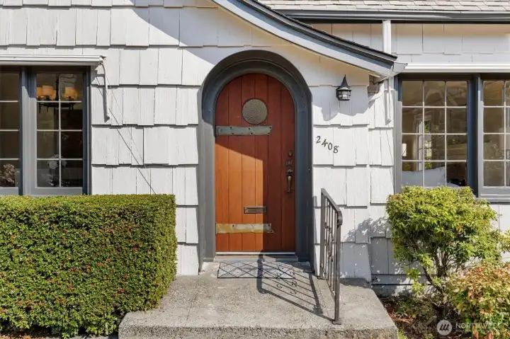 Custom built solid wood front door with vintage hardware.