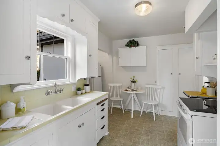 Charming kitchen with period tile work and eating space.