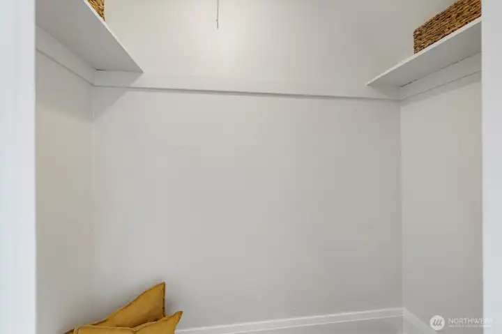 Walk in closet in primary bedroom.
