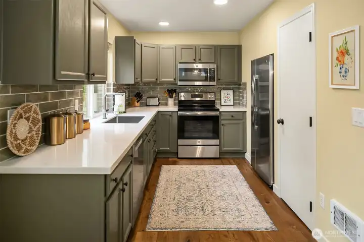 Kitchen with new countertops, back splash, and appliances