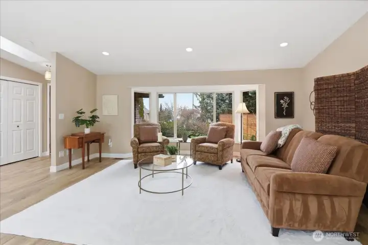 Inviting living area with oversized windows, natural light, and a warm, comfortable feel.