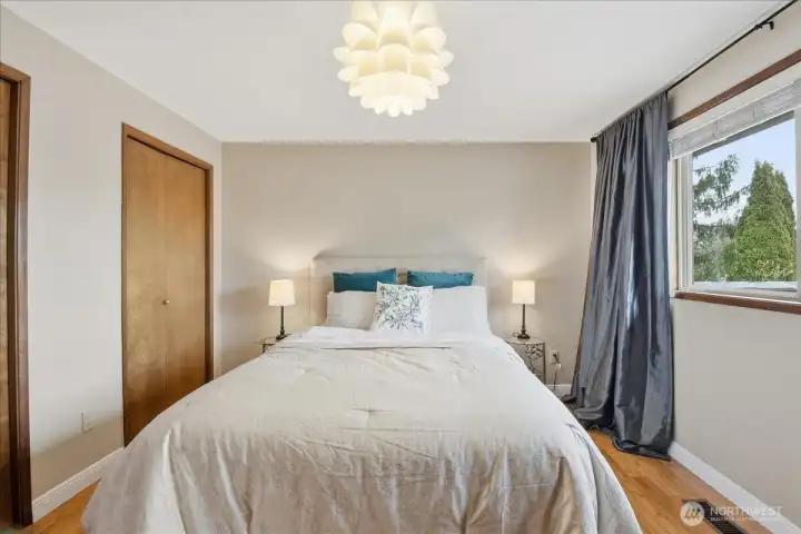 Comfortable secondary bedroom with hardwood floors, double closet, and great natural light.