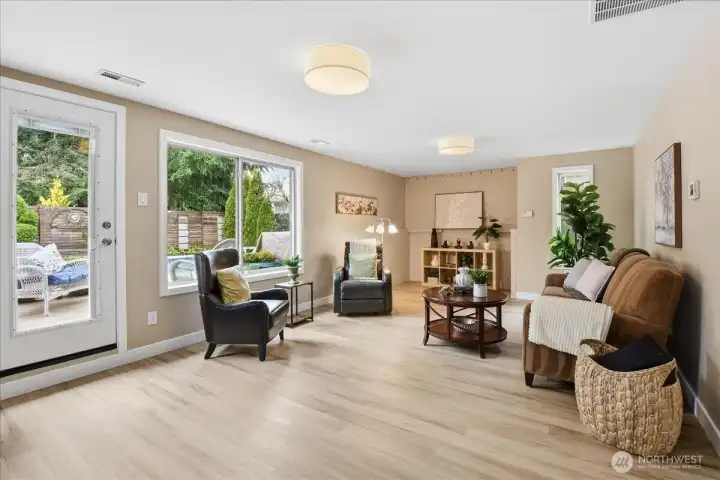 Spacious lower-level family room with patio access and easy connection to the hot tub and in-ground pool.