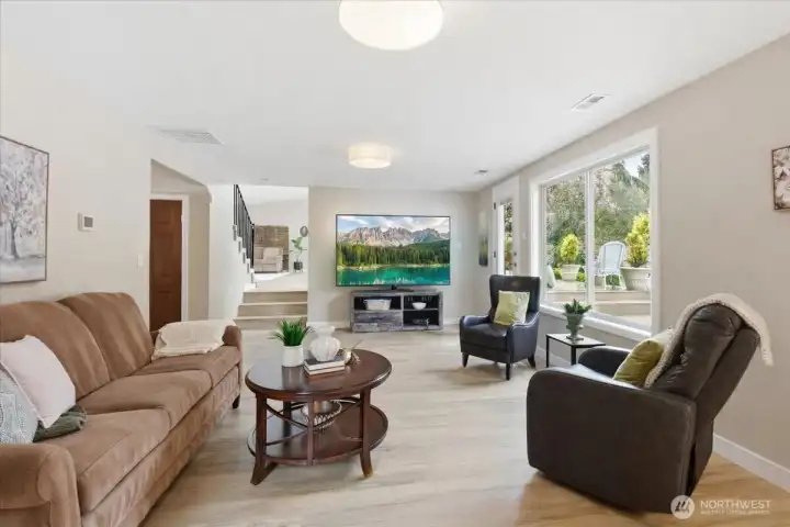 Expansive lower-level living space with patio access, oversized windows, and great flexibility for relaxing or entertaining.