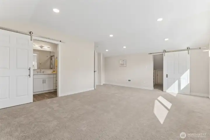 Upstairs Primary Bedroom with Barn Door to Private Bathroom