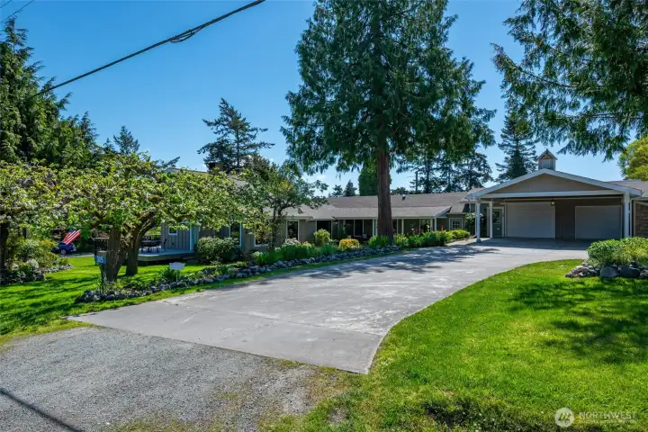 Expansive sweeping driveway, with large carport and two car garage including RV/Boat parking in the back. See virtual tour link for floorplans and more photos.