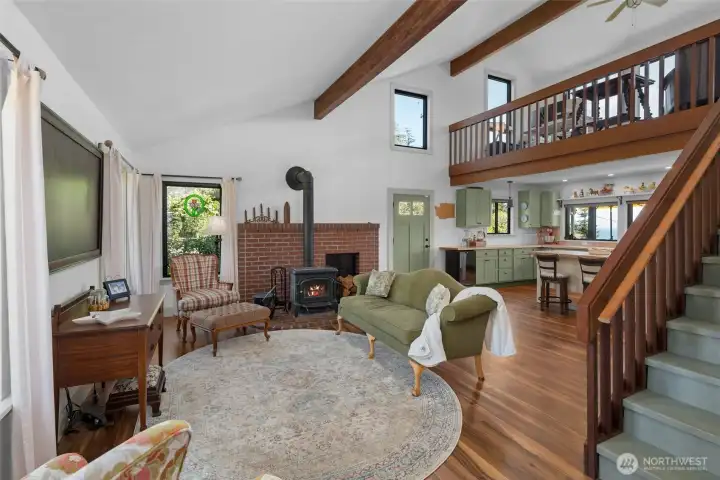 Stunning living room, vaulted ceilings with exposed beams, plenty of large windows gathering in natural light.