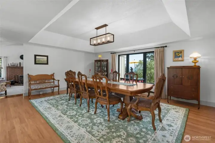 Grand dining room, with a recessed ceiling and large view windows on both sides.