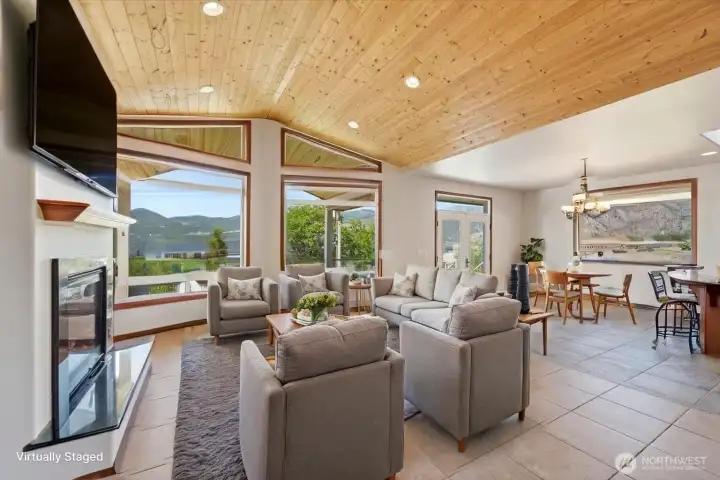 Vaulted wood ceilings create a warm and inviting atmosphere while framing spectacular lake and mountain views. (Virtually Staged) Vaulted wood ceilings create a warm and inviting atmosphere while framing spectacular lake and mountain views. (Virtually Staged)