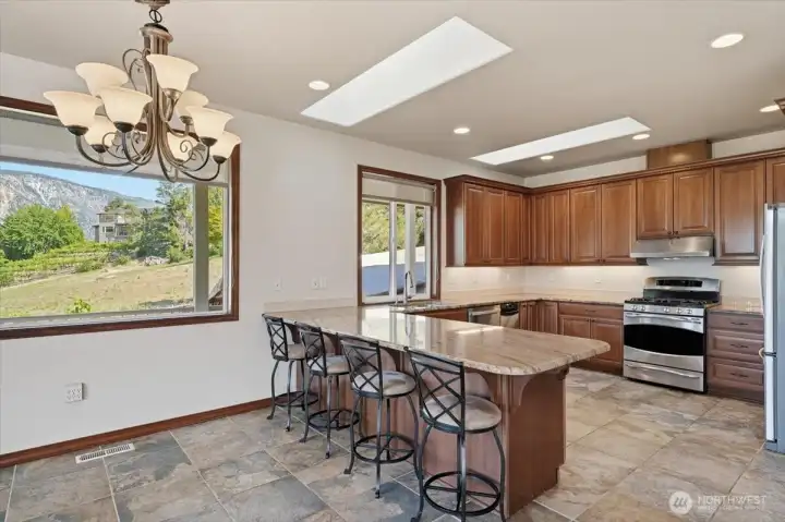 Functional kitchen design offering generous workspace and seamless flow to dining and outdoor living areas. Functional kitchen design offering generous workspace and seamless flow to dining and outdoor living areas.