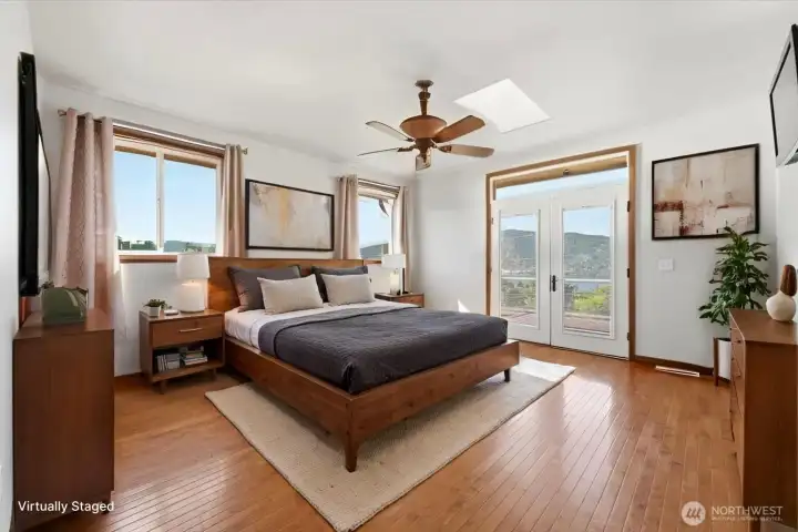 Wake up each morning to panoramic lake and mountain vistas from the comfort of your primary suite. (Virtually Staged) Wake up each morning to panoramic lake and mountain vistas from the comfort of your primary suite. (Virtually Staged)