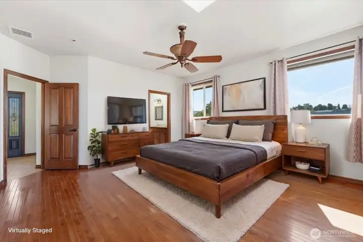 Spacious primary bedroom designed for relaxation and everyday luxury. (Virtually Staged) Spacious primary bedroom designed for relaxation and everyday luxury. (Virtually Staged)