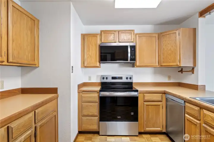 Lots of cabinet space in this kitchen, featuring a brand new dishwasher, refrigerator, oven and microwave.