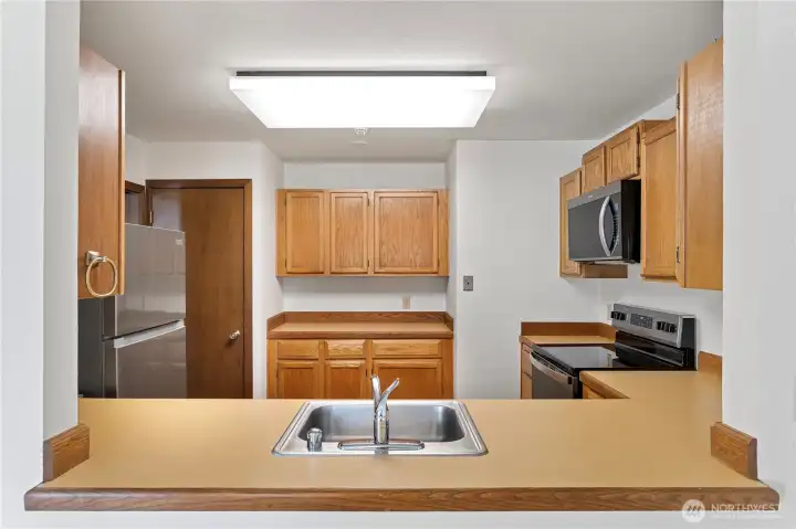 A buffet style counter in the kitchen with a kitchen pantry to add even more storage.