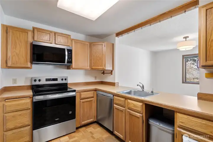 The kitchen opens up to the dining area, lots of light, counter space and extra space for more than one cook!