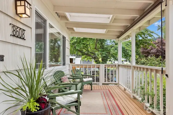 Covered front porch/deck with sunshade provides a nice place to relax