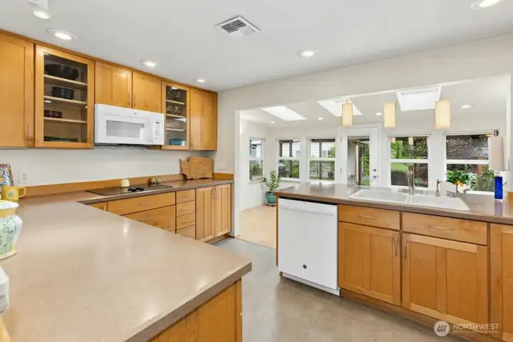 Loads of space and sunlight flood the kitchen from the sunroom/dining area