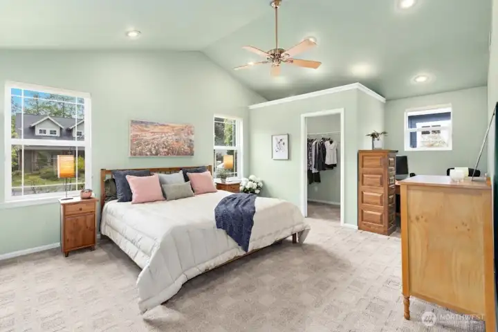 The primary suite with vaulted ceilings and reading/office nook area also has a walk-in closet!
