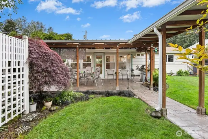 The breezeway leads to the additional outbuilding with heated studio, storage area and toolbench area
