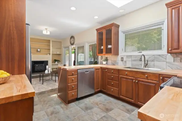 Gorgeous butcher block counters and SS appliances complete this kitchen