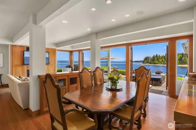 Dining room with views of the water. Double french doors open to allow indoor/outdoor living