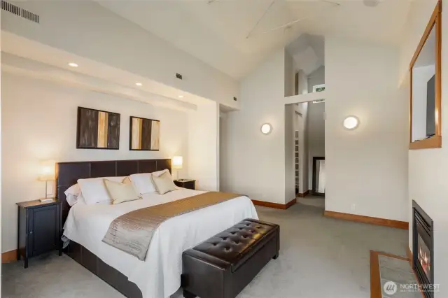 Primary bedroom with vaulted ceilings and two walk-in closets