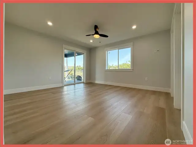 Relax in this primary ensuite featuring a door to the back covered deck. This space is located on the back NW corner of the home.