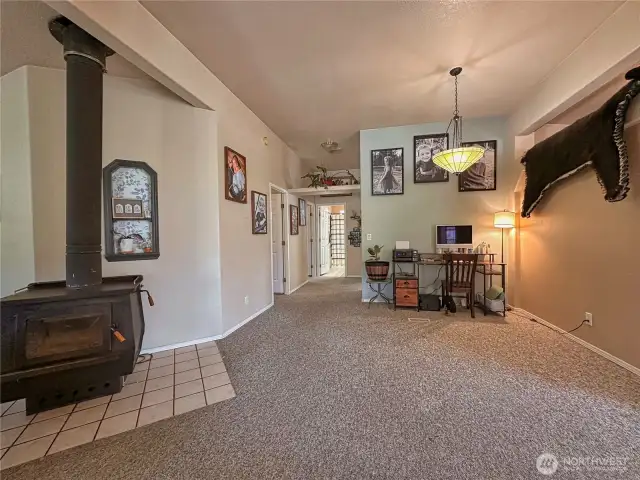 There's even a cozy wood burning stove located near middle room used as office space