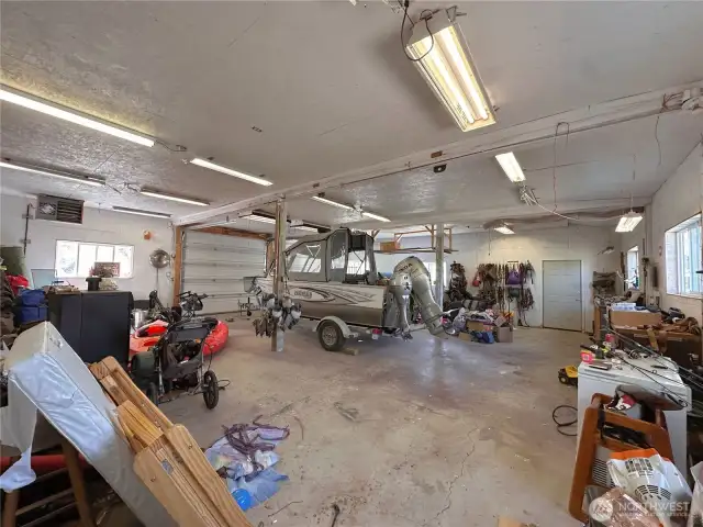 Interior of heated detached garage/shop (boat not included) gives you more enclosed equipment & parking space, plus workshop area