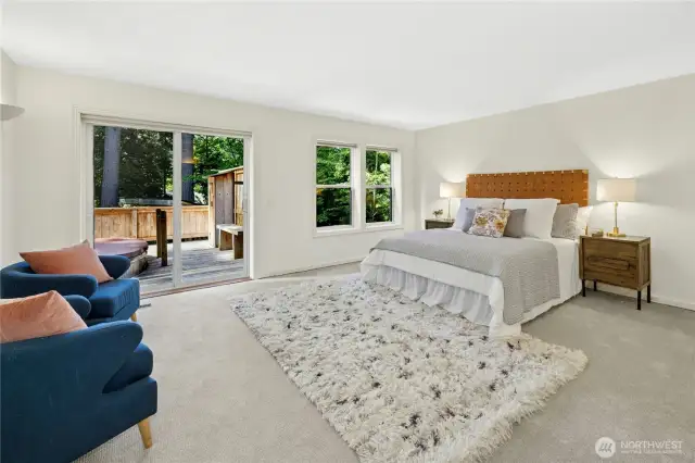 Off of the great room, the primary bedroom has a walk-in closet, ample room for a sitting area plus it has direct access out to the back deck and large hot tub.