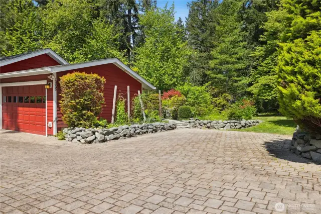 The flat driveway has custom pavers, which makes for an easy approach. There is ample parking including space for an RV.