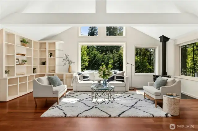 Welcome inside to bright walls of windows and dramatic vaulted ceilings.