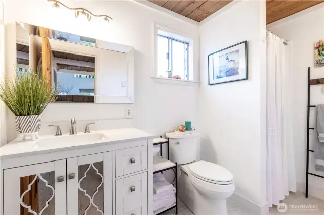 Bathroom, new vanity, mirror and toilet.