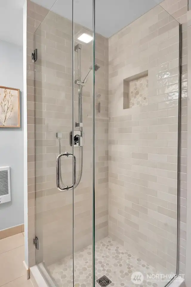 Primary bathroom has a remodeled shower