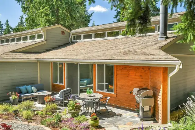 Attached outdoor shed for tools and storage is on the far left in this photo