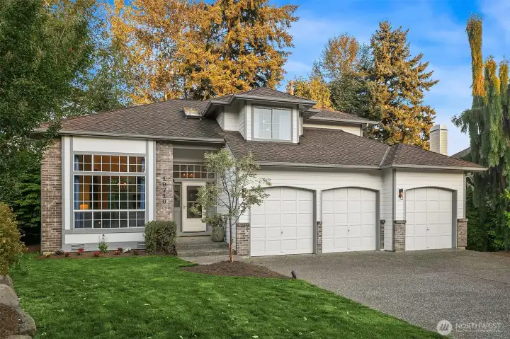 Beautiful setting for this updated 90's home with a 3 car garage and large flat driveway. Newer roof and gutters updated landscaping and exterior lighting. West facing for tons of natural light! Central air to keep it all cool in the summer!