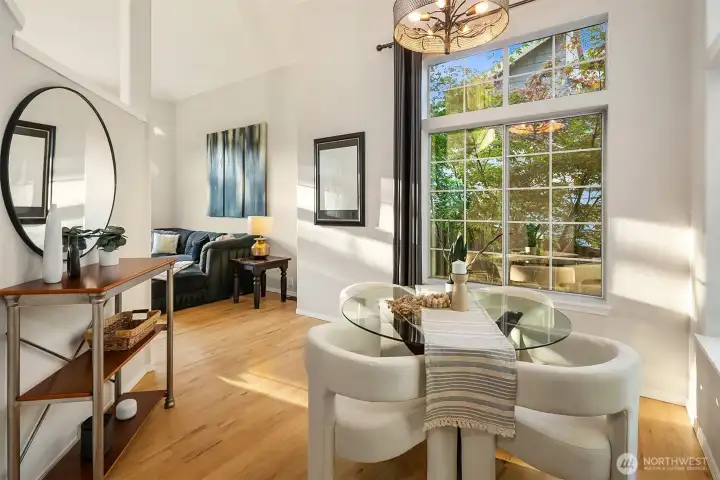 Dining room flows from the living room and has the same vaullted ceilings, custom lighting and more double high windows.