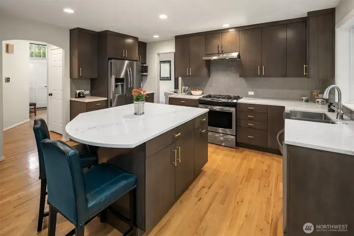 Custom island with quartz countertops, great storage and room for bar stools.