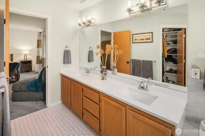 Plenty of space and storage with this oversize vanity. Peek a boo view in the mirror of the custom closet system installed in 2022.
