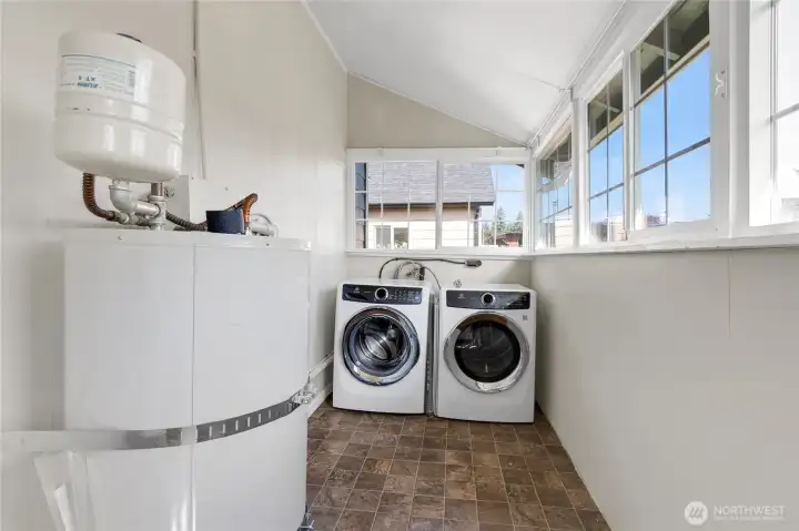 Oversized laundry/utility room wrapped in windows—light-filled space with endless storage and flexibility.