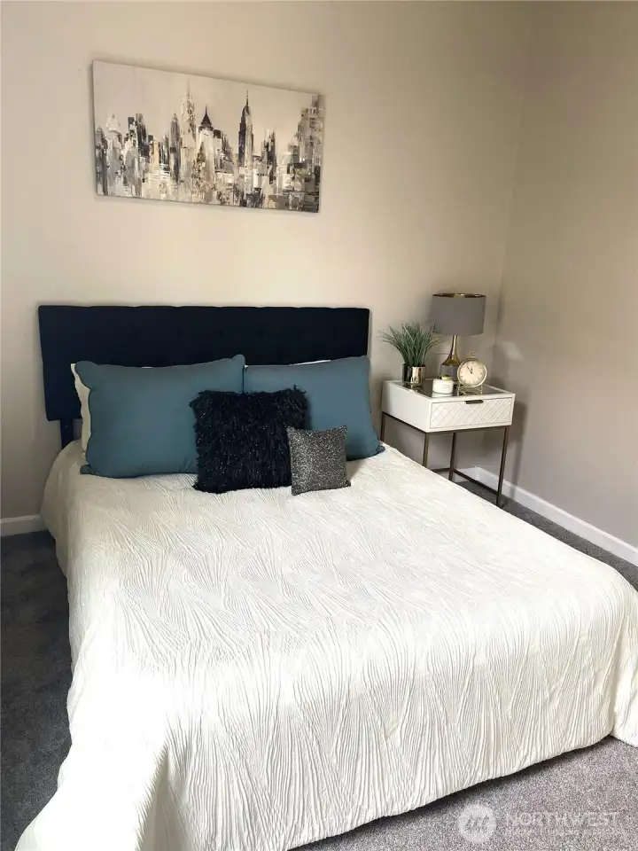 Designed as a restful escape, this primary bedroom retreat shows just how spacious it really is—with a QUEEN bed, nightstand, and plenty of breathing room.