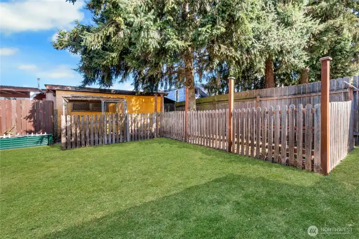 Fenced dog run for your four-legged friends plus raised garden beds ready for fresh plantings.