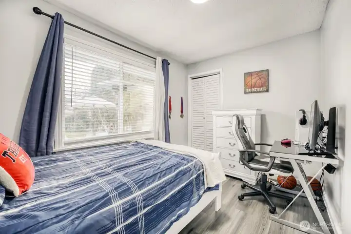 Comfortable bedroom filled with natural light and clean neutral design.