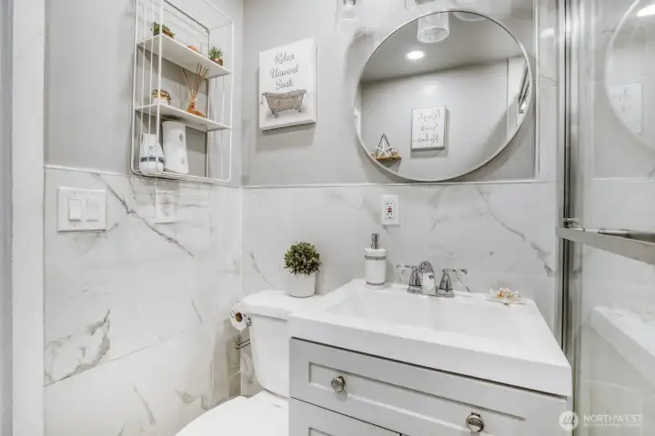 Updated bathroom featuring modern vanity, stylish mirror, and clean contemporary finishes.