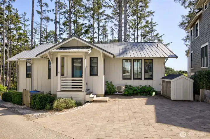 When you enter the home you are greeted with custom driveway pavers, a bike shed and a garbage enclosure to keep your outside clean and tidy.