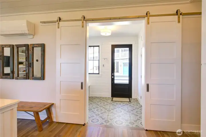The barn doors can be closed to contain the entry or leave it open for the airy feel.