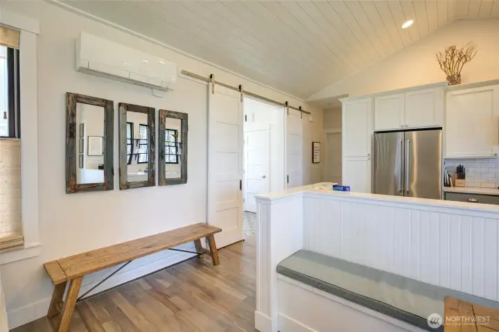 Vaulted tongue and groove ceiling add to the relaxed feel of this home. There is also a built in dining bench shown on the right.